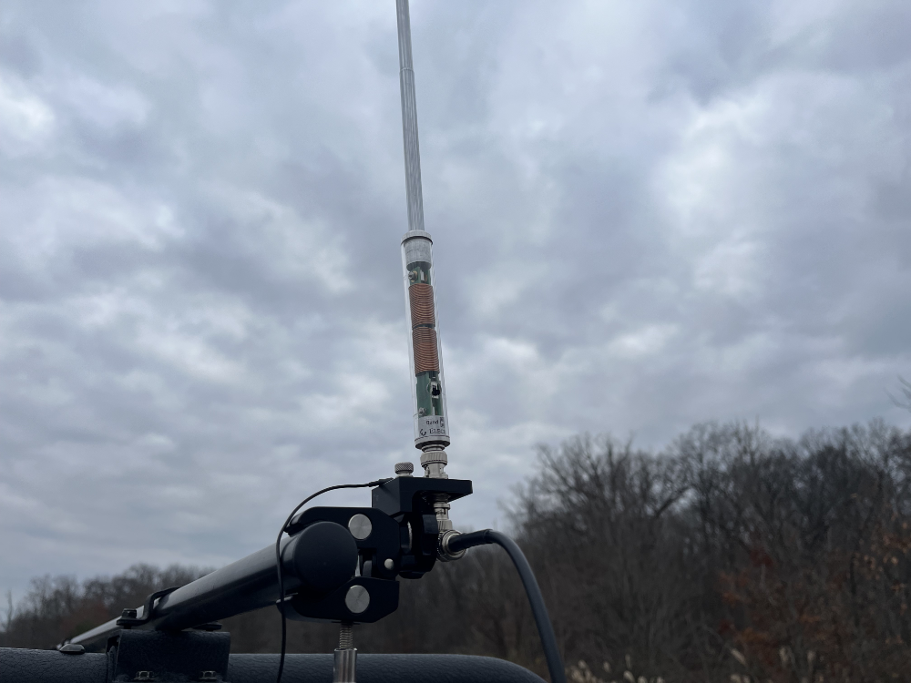 A close up of the AX1 mount attached to the cargo bar on the Jeep.