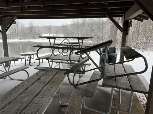 Picnic tables piled up in the shelter for the winter.