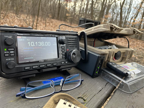 IC-705 and gear with glasses on a picnic table.