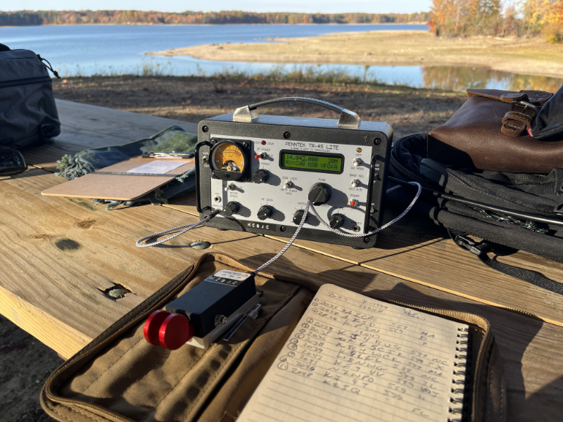 Penntek TR-45L with paddles and log book on a picnic table.