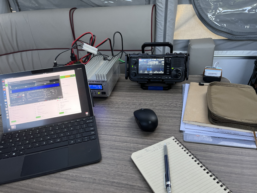 Surface Go 2, HR50 amplifier, IC-705, logbook, and mouse on a table in a camper.